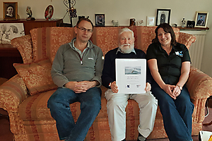 Patrick Thomas receiving his copy of the project's report